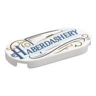 Visuel indicatif Rebrickable de Tuile ronde 2 x 4 avec bleu foncé 'HABERDASHERY', or Décorations motif imprimé (Tile Round 2 x 4 with Dark Blue 'HABERDASHERY', Gold Decorations Print)