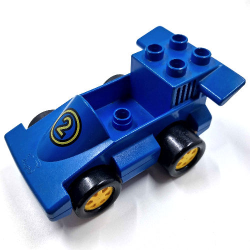 Visuel indicatif Rebrickable de Duplo voiture formule un avec un tenon dans la cabine, fond bleu et jaune numéro 2 motif imprimé (Duplo Car Formula One with One Stud in Cab, Blue Bottom and Yellow Number 2 Print)